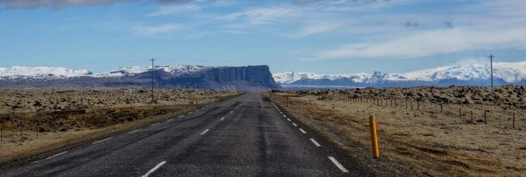 A road between fileds of mosscovered lava