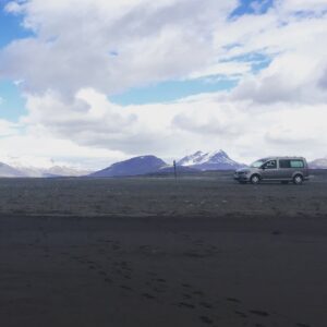 Camper on a black sand beach