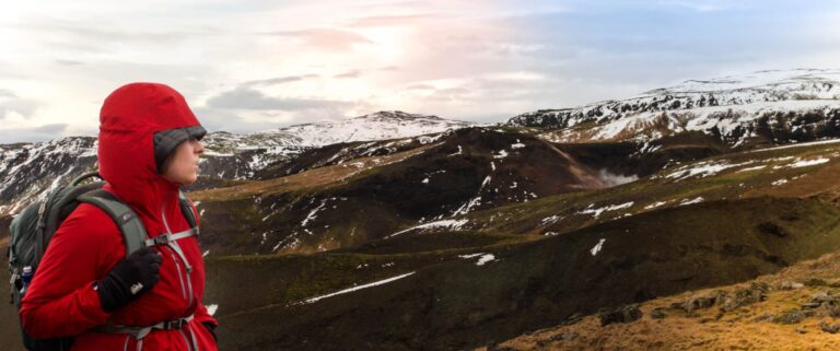 woman wearing red jacket and mountains with snow
