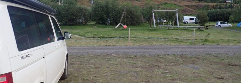 rent.is camper pakred by a campsite with playground