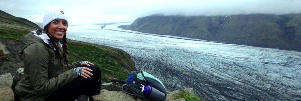 woman smiling sitting on a mountain in iceland