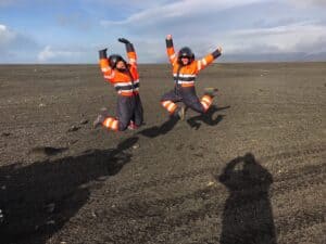 Happy adventurers on a black sand beach