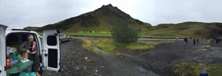 woman sitting inside campervan eating