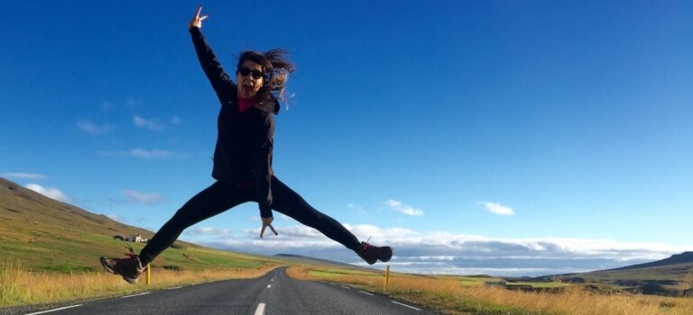 Iceland Ring Road Travel Guide Woman jumping in the air