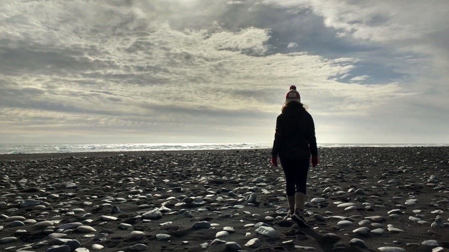 Walking on a black sand beach