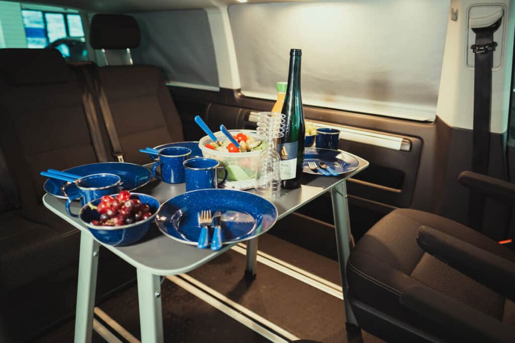 VW California 4×4 camper interior table with cutlery and dishes