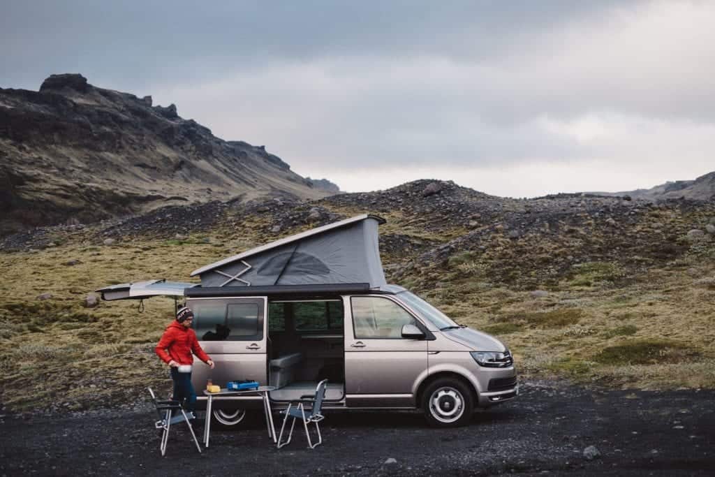table and chairs outside a VW california camper