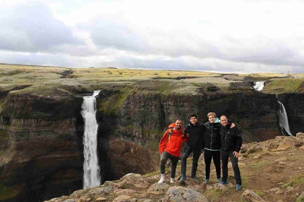 Three guys standing by a cliffs edge