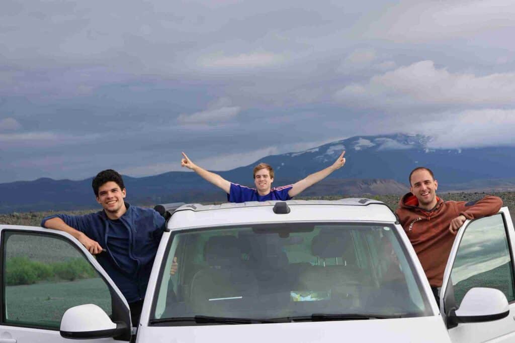 Three guys standing out of the VW California.