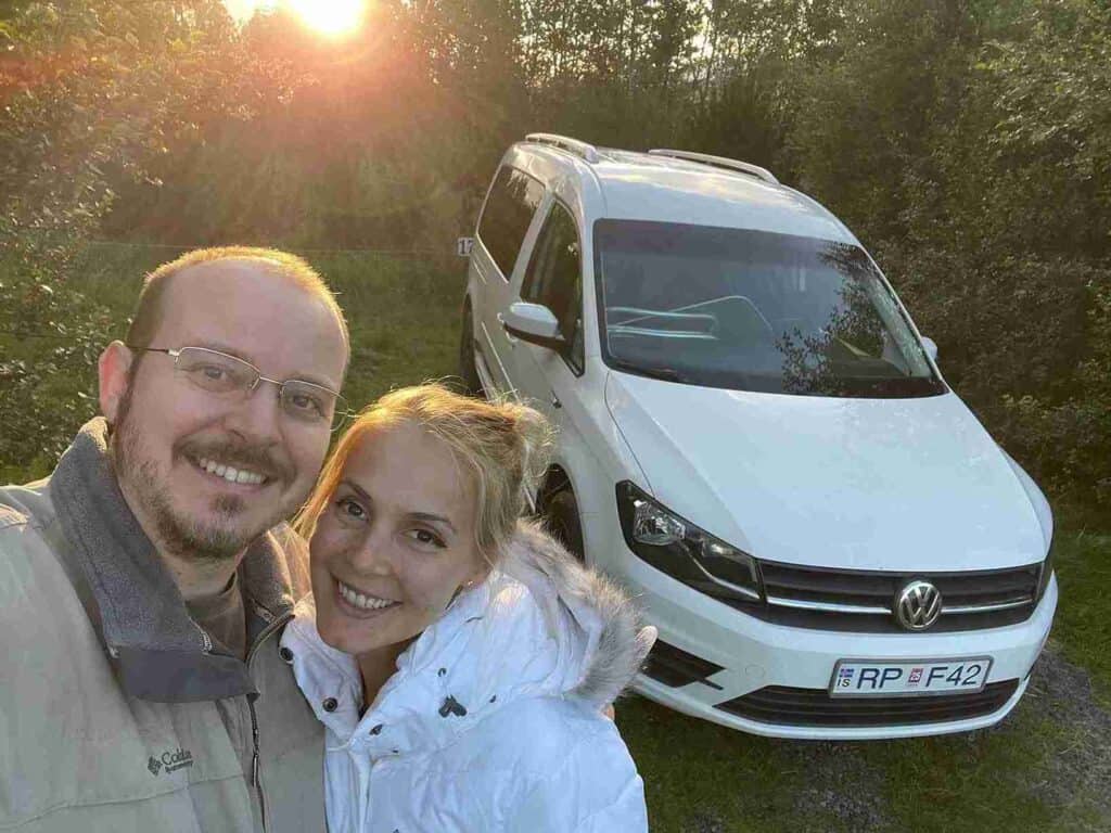 A couple standing by the caddy camper