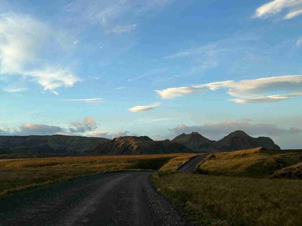 A road ahead with green surroundings