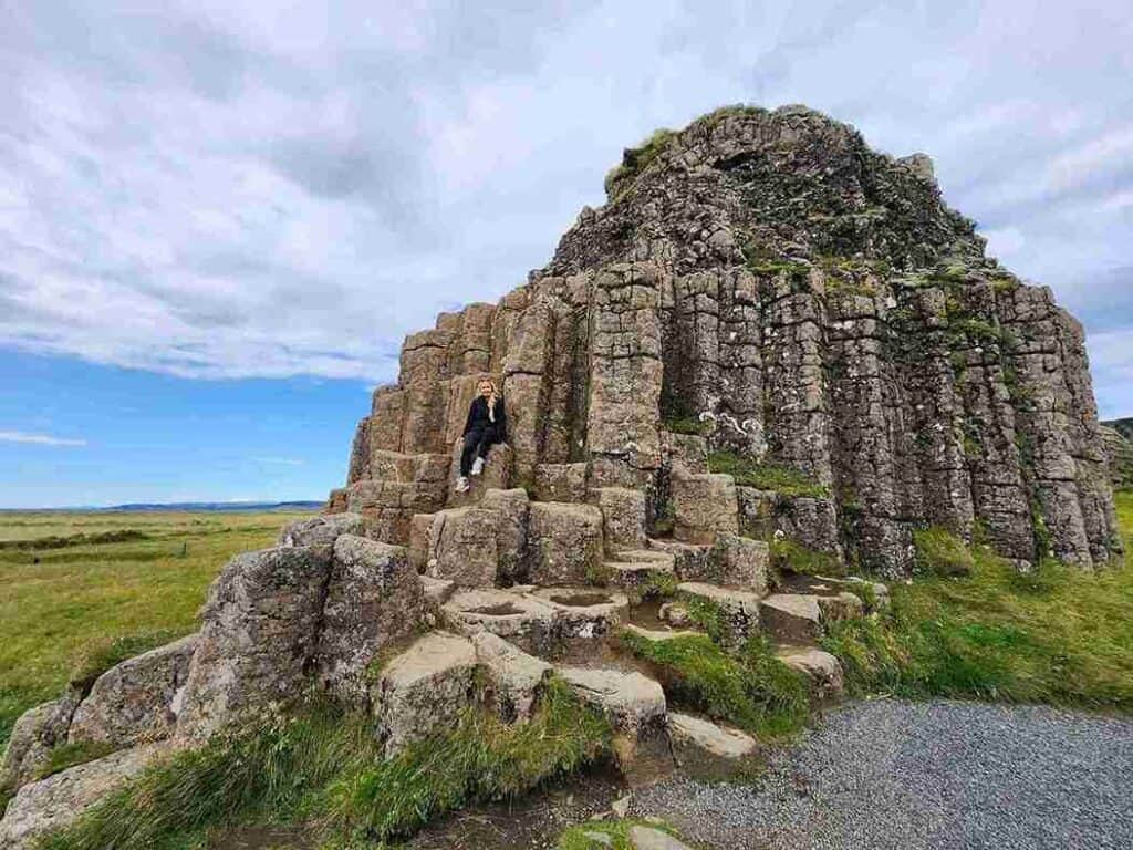 A woman sitting on a rock formation