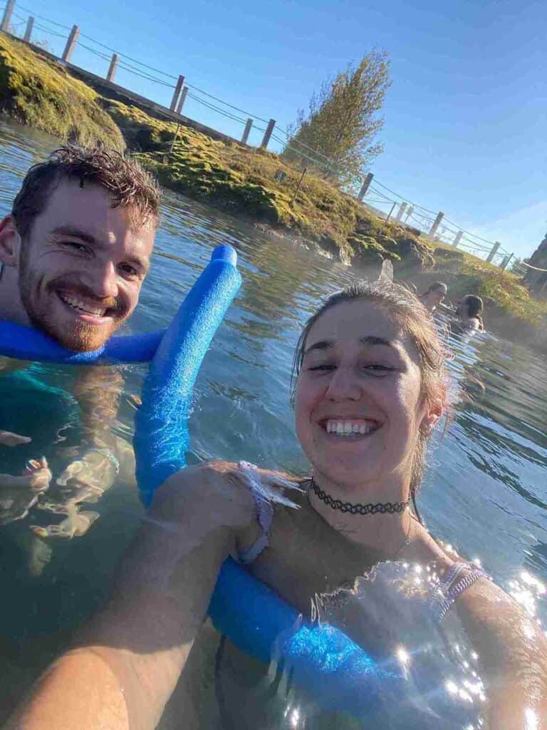 A couple swimming in the secret lagoon