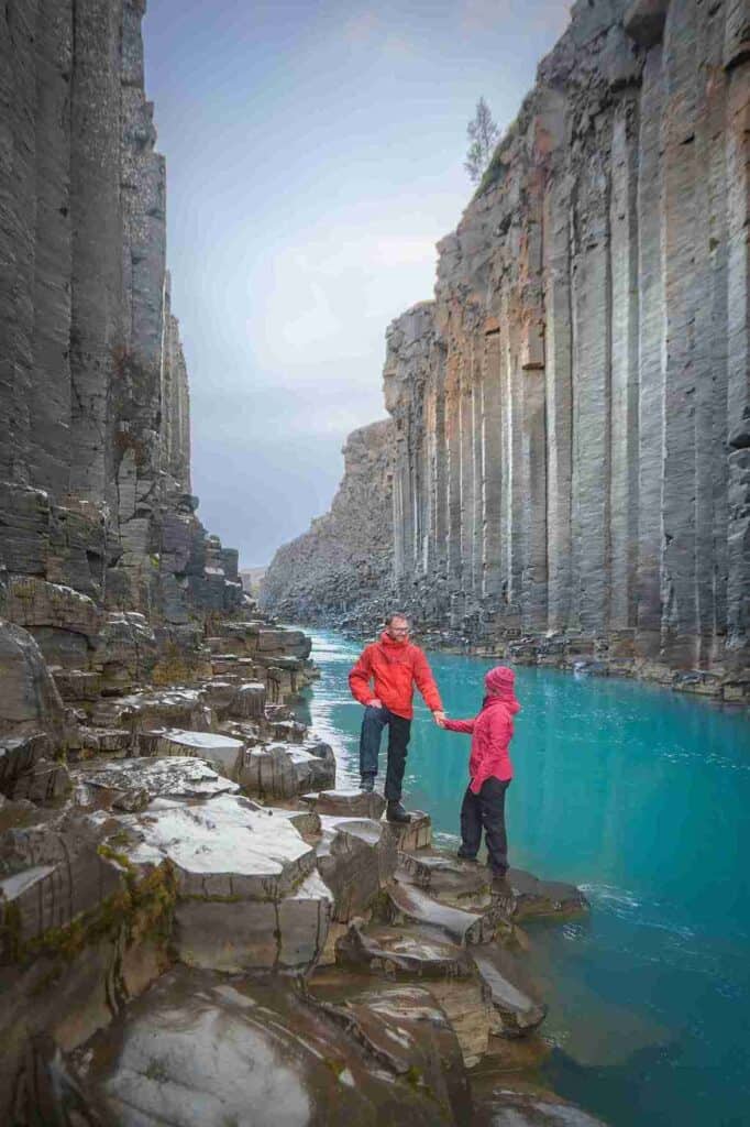 A couple in a blue watered canyon