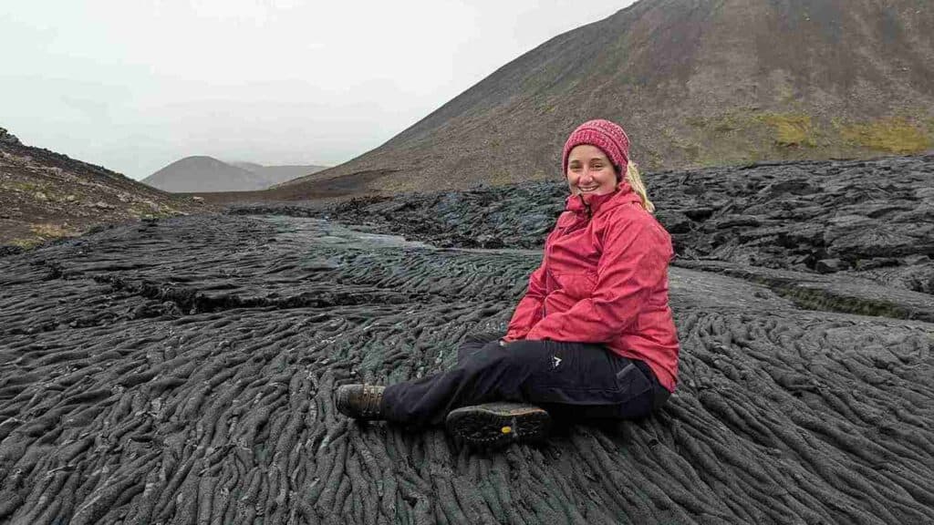 A woman sitting on old lava