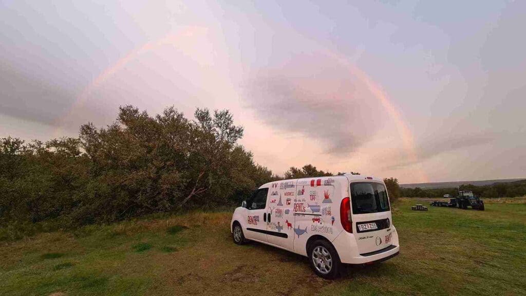 Camper on a campsite and a rainbow