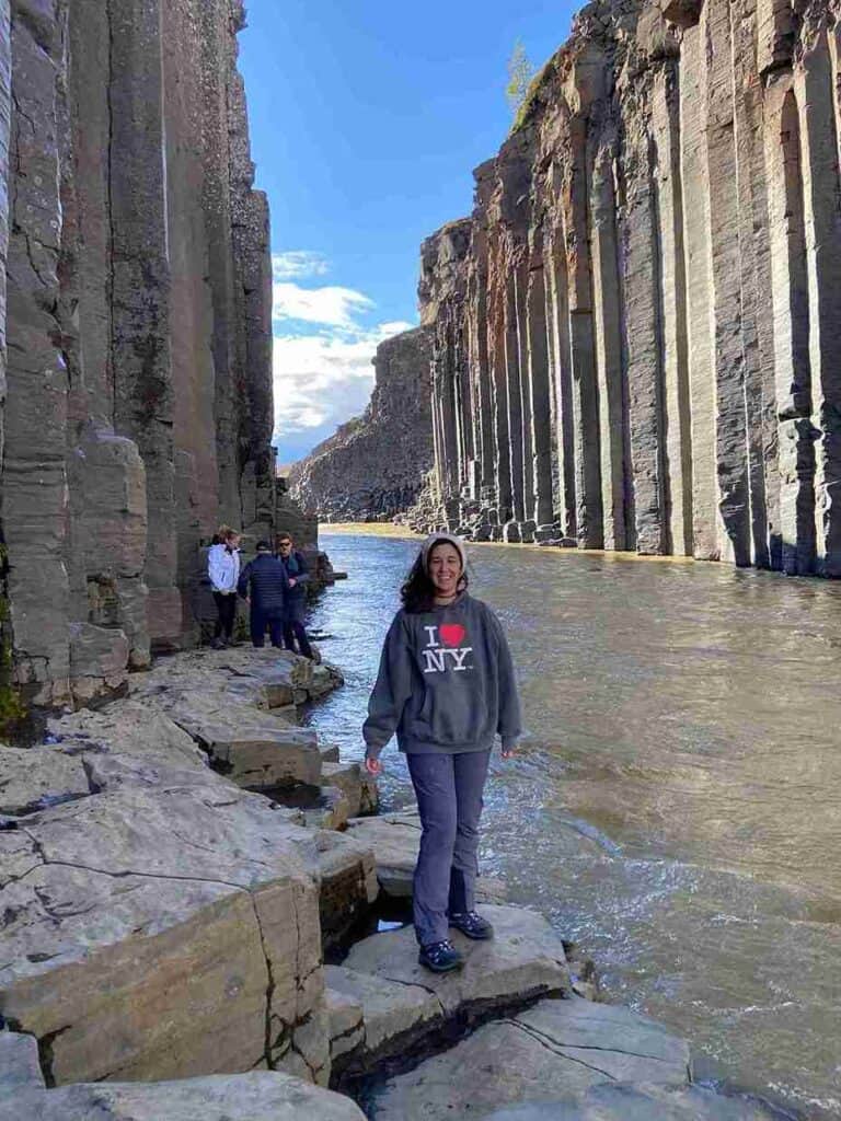 A woman standing by the stuðlagil canyon
