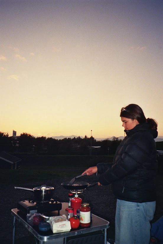 A girl cooking on a camping stove