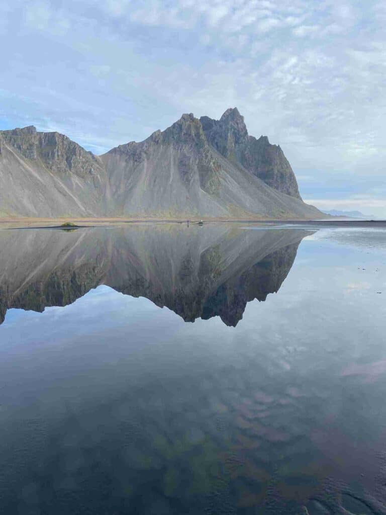 A mirror like lake by a beautiful mountain